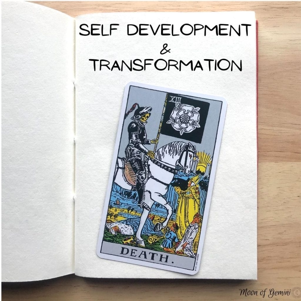 self development and transformation written on notebook with death tarot card