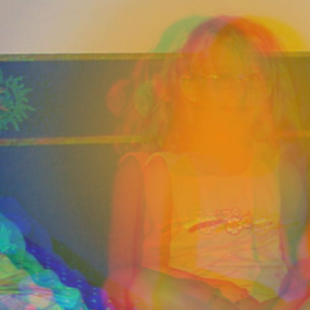 edited image of young child in a yellow/white light