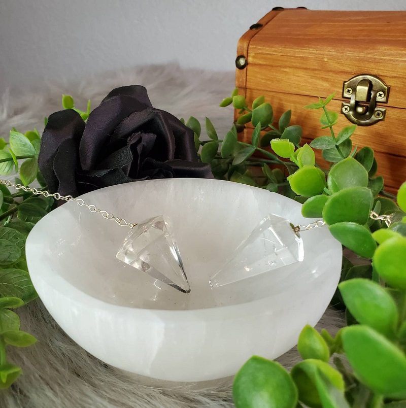clear quartz pendulums in selenite bowl